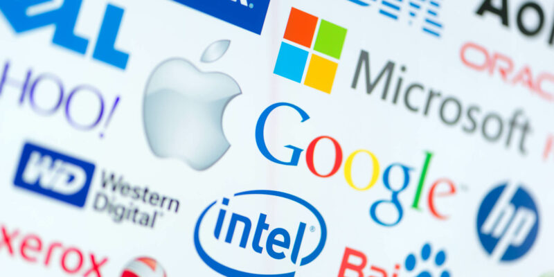 A logotype collection of well-known world top companies of computer technologies on a monitor screen. Include Google, Apple, Microsoft, Intel and other logo.