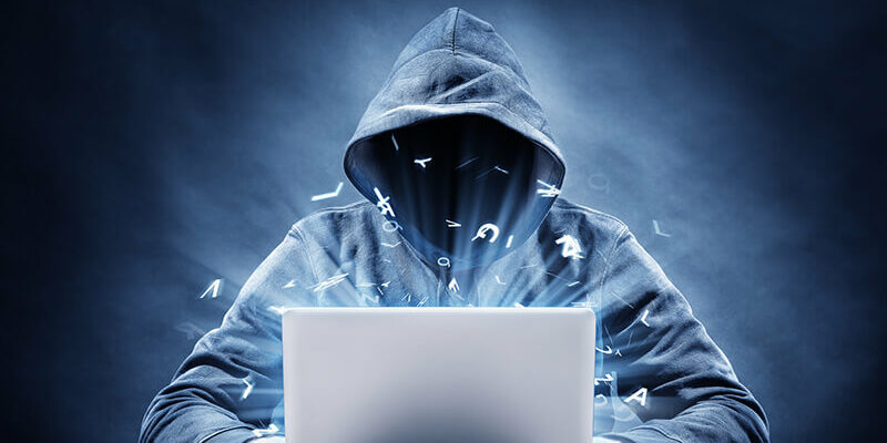Hooded man as hacker