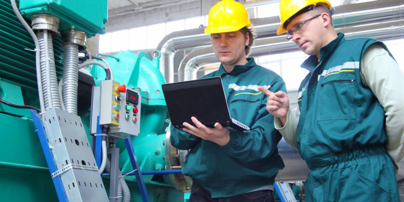 Industrial workers with laptop, teamwork
