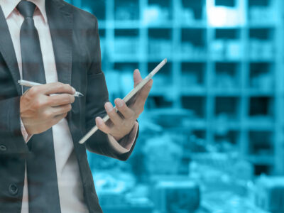 Businessman using the tablet on Abstract blurred photo of book store background