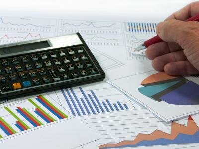 data graphics analysis with calculator and writing hand