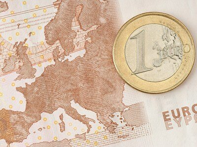 One Euro Coin on Euro Banknote showing Map of Europe