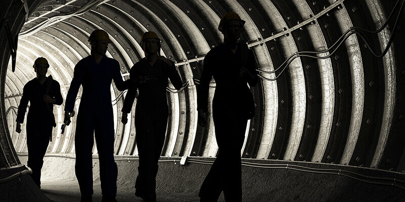Silhouette of workers in mine