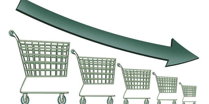 Sales decline symbol as a group of shrinking shopping carts with a dark arrow going down