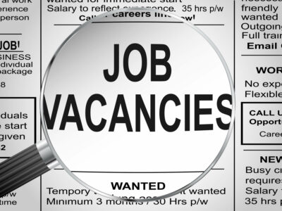 Newspaper clipping. Jobs vacancies under magnifying glass