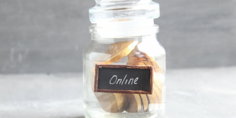 internet banking idea, jar with money and sign online