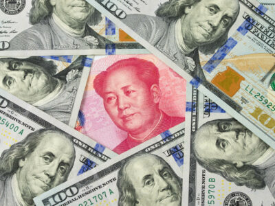 US one hundred dollar bills surrounding against China Yuan note