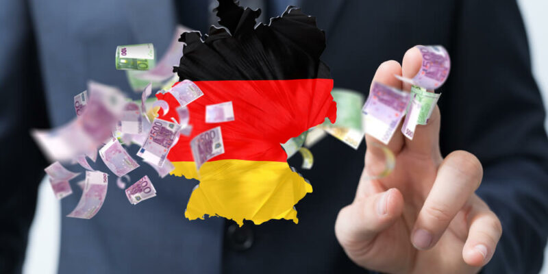A 3d illustration of the map of Germany and money floating near a hand, economy