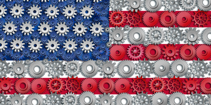 American economy symbol represented by gears and cogs in the shape and color of the flag of the U.S.A. showing industry business and manufacturing working toget
