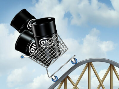 Rising oil prices with a group of oil barrels or steel drum containers in a shopping cart going up on a roller coaster