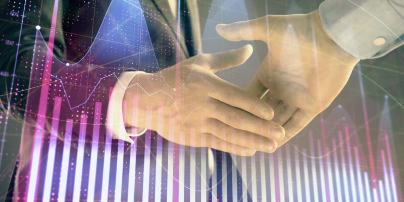Multi exposure of forex graph on abstract background with two businessmen handshake.
