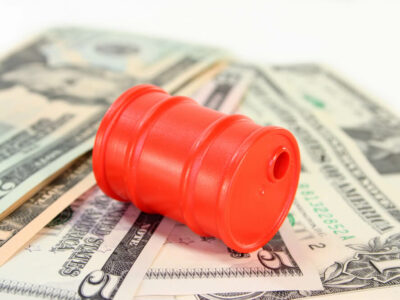 a barrel and dollar bills on a white background