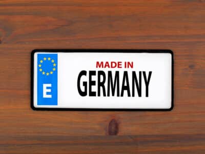 Made in Germany. On a wooden board metal plate with european union flag