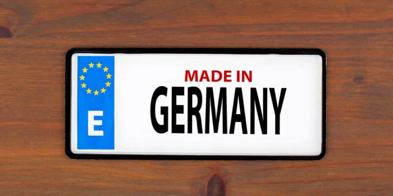 Made in Germany. On a wooden board metal plate with european union flag