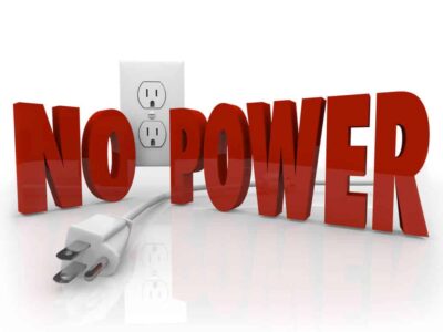 The words No Power in red letters in front of an electrical outlet and an unplugged cord to symbolize an electricity outage or energy failure