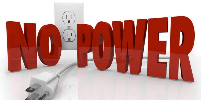 The words No Power in red letters in front of an electrical outlet and an unplugged cord to symbolize an electricity outage or energy failure