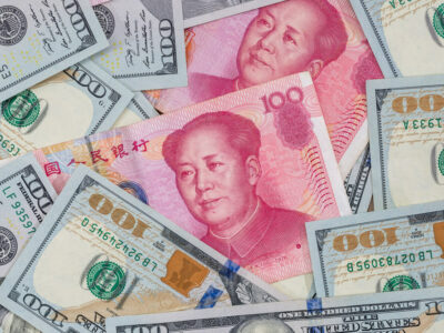 Chinese Yuan bills vs U.S. dollar as background .