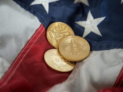 Golden Digital Cryptocurrency Coin Bitcoin on United States American Flag. USA Virtual Currency Concept With Copy Space.