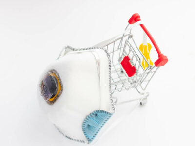 white respirator and toy cart for shopping. Epidemic deficit concept