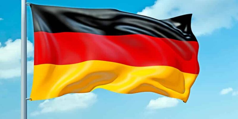 An image of a German flag in the blue sky