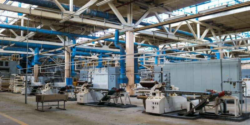 Beautiful metal industrial equipment of a production line at a machine-building plant, a conveyor with machine tools for products. Equipment refinery, petrochemical, chemical plant.