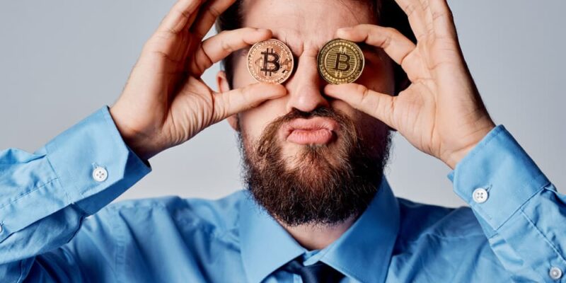 Business man cryptocurrency Bitcoin near face emotions finance technology. High quality photo