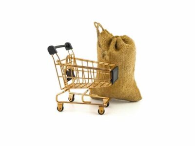 Empty golden shopping cart and jute bag isolated on white background