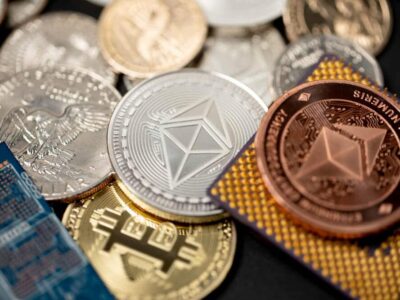 Ethereum coin in gold and copper, next to microchip and us one dollar coin. Concept of crypto mining,