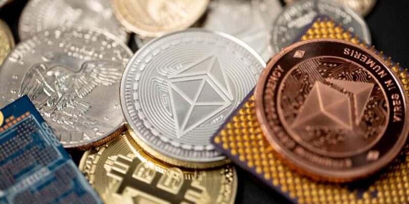 Ethereum coin in gold and copper, next to microchip and us one dollar coin. Concept of crypto mining,