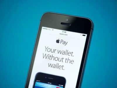 Close-up shot of brand new Apple iPhone 5S showing apple.com website with news announce of Apple Pay service.