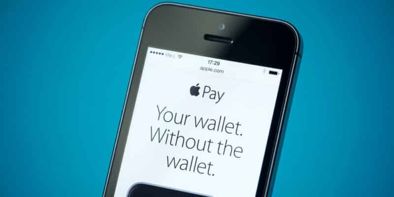 Close-up shot of brand new Apple iPhone 5S showing apple.com website with news announce of Apple Pay service.