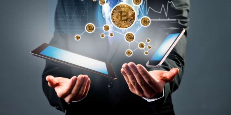 Digital scheme with businessman hand with tablet and smart phone. Concept showing bitcoins curency, global connection, internet and technologies, graphs and future payment.