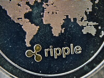 Digital currency physical metal silver ripple coin. Cryptocurrency macro concept.