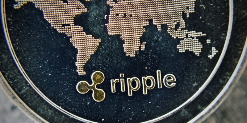 Digital currency physical metal silver ripple coin. Cryptocurrency macro concept.