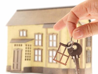Handing keys in the house background isolated