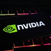 Viersen, Germany - May 1. 2021: Closeup of mobile phone screen with logo lettering of nvidia corporation on computer keyboard