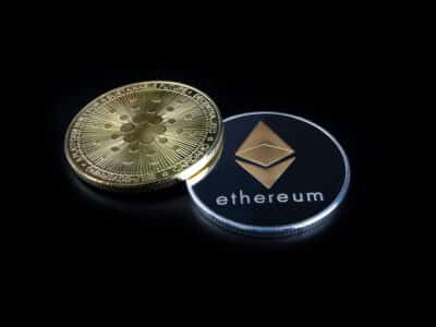 ETHEREUM (ETH) cryptocurrency; silver ethereum coin on isolated black background. CARDANO (ADA) coin. Concept coin.