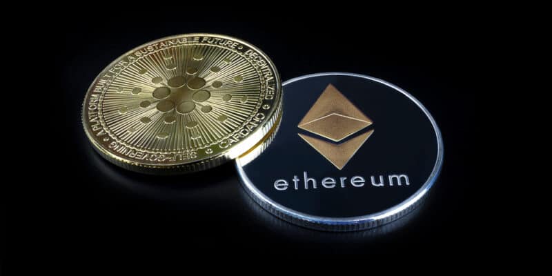ETHEREUM (ETH) cryptocurrency; silver ethereum coin on isolated black background. CARDANO (ADA) coin. Concept coin.