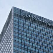 London, United Kingdom - February 03, 2019: Sun shines on J P Morgan signage at top of their UK branch at Canary Wharf. JPMorgan Chase is US multinational investment bank founded (originally) 1799